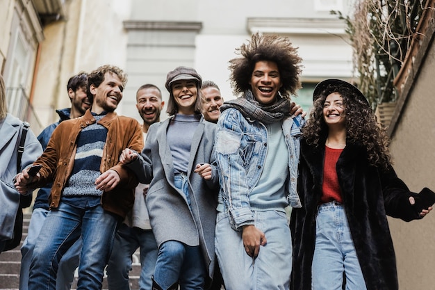 Happy diverse friends having fun around the city - Focus on right girl face