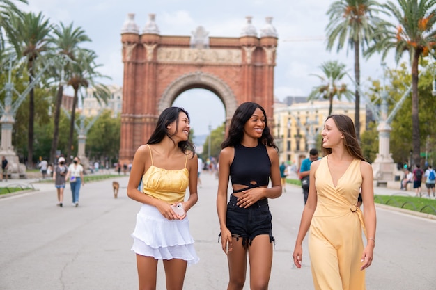 Happy diverse women walking on street