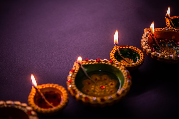 Happy Diwali - Beautiful Diwali diyas at night with flowers