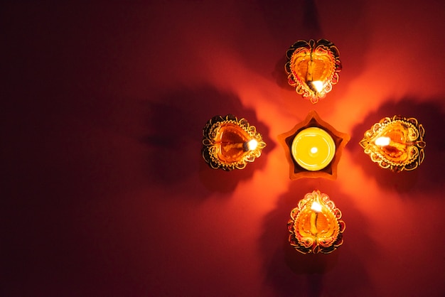 Happy Diwali - Clay Diya lamps lit during Dipavali, Hindu festival of lights celebration.