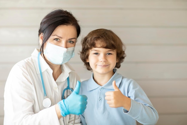 happy doctor and his patient boy smile and look at the camera