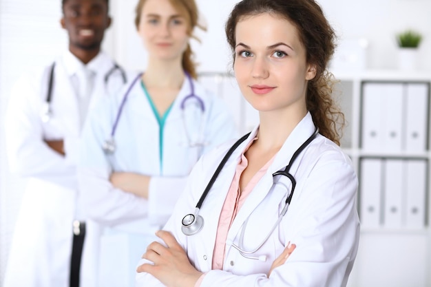 Happy doctor woman with medical staff at the hospital