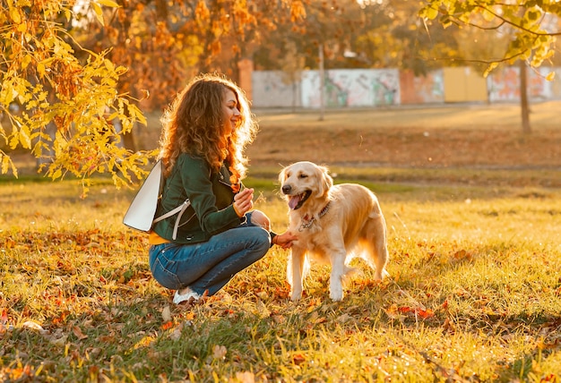 Happy dog and his owner in the park on a sunny day