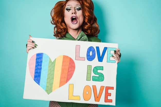 Happy drag queen holding gay pride banner  Lgbtq and concept  Focus on face