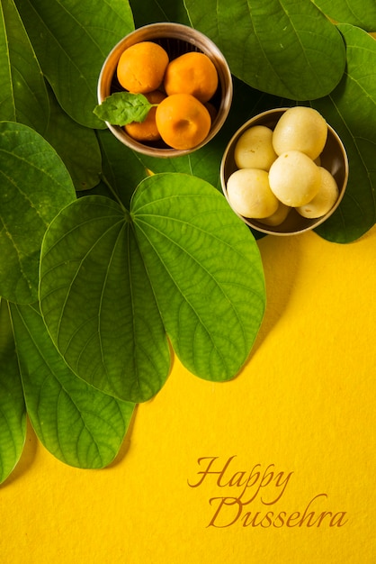 Happy Dussehra greeting card using medlar fruits, bidi leaves and indian sweet pears