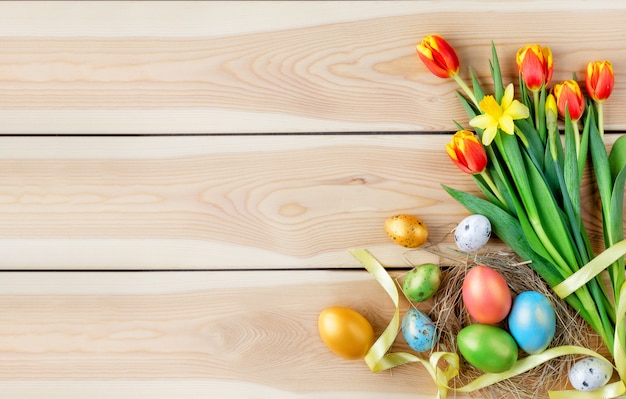 Happy Easter concept. Congratulatory easter background. Easter eggs and flowers.