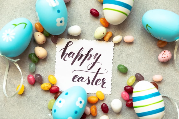 Happy easter concept preparation for holiday easter eggs inscription happy easter letters candy choc...