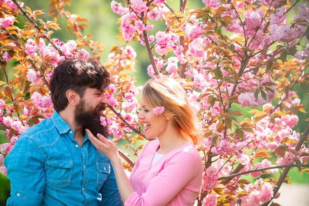 Happy easter day couple near sakura tree happy couple in love outdoors couple in love