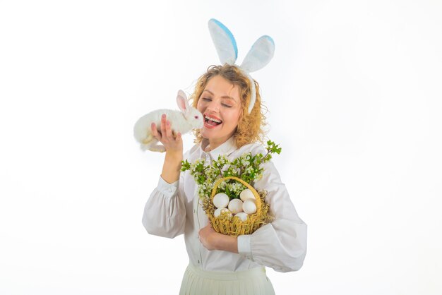 Happy easter day tradition of easter girl in bunny ears holds basket with eggs and easter bunny