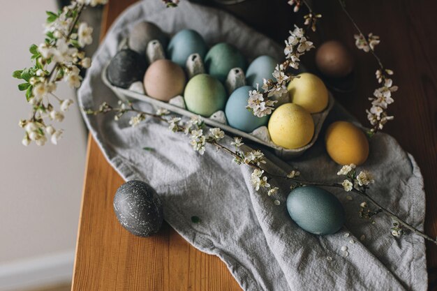 Happy Easter Easter eggs on rustic table with cherry blossoms Countryside still life