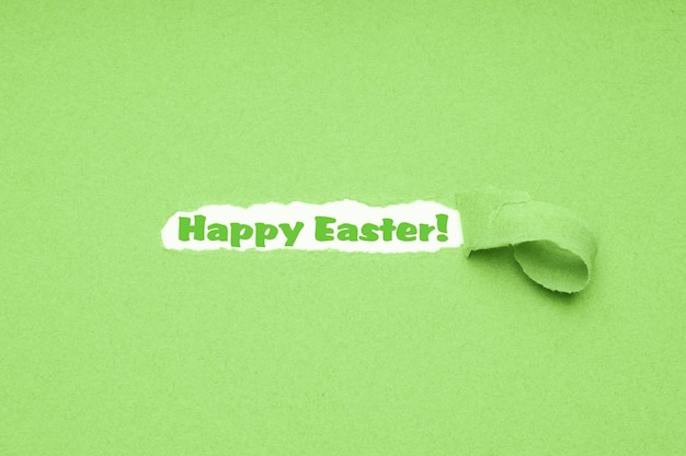 Happy Easter greeting on torn green paper background