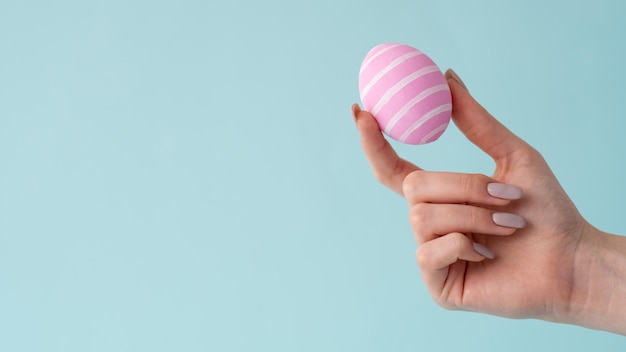 Happy easter holiday decoration pink egg hand blue