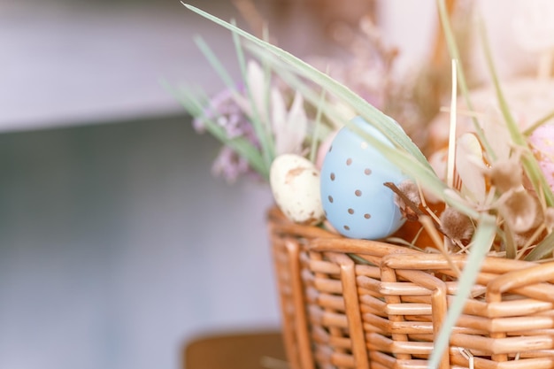 Happy easter holiday time in spring season basket with painted eggs easter baked cakes flowers and plants and sweet rabbits festive home decor traditional food mockup and space for text flare