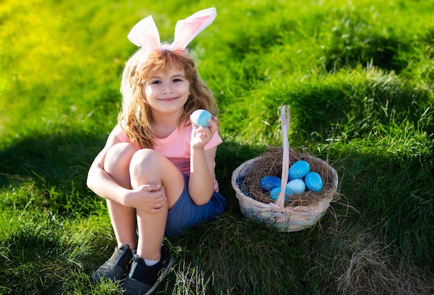 Happy easter kids in bunny ears with easter egg in basket boy play in hunting eggs