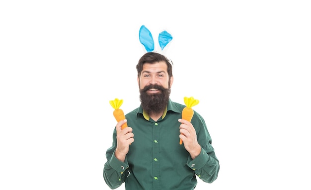 Happy easter man in rabbit ears ready for bunny hunt holding carrot easter