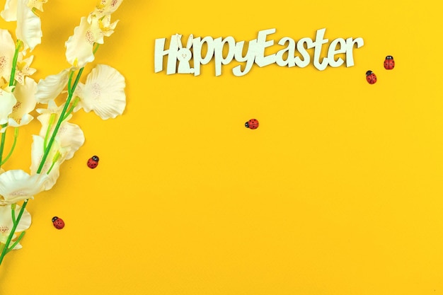 Happy Easter text background with spring flowers, copy space photo