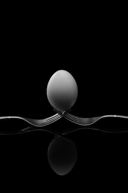 Happy Easter, white egg two forks ancient silver on black