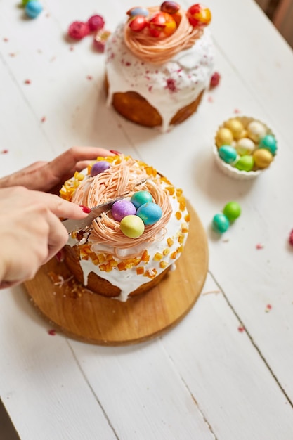 Happy Easter Woman cut Easter cake for the holiday The concept of preparing for the Easter holiday