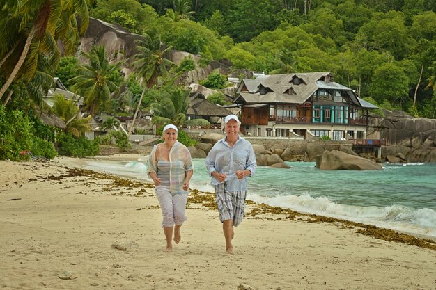 Happy elderly couple rest at tropical beac