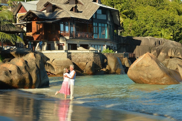 Happy elderly couple rest at tropical beach