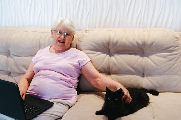 Happy elderly woman using laptop computer home Senior mature older woman watching business training