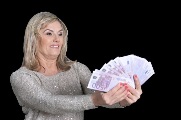 Happy elderly woman with euros