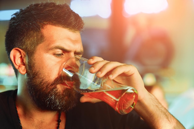 Happy elegant man drinking beer Man with beer Beard man drinking beer from a beer mug