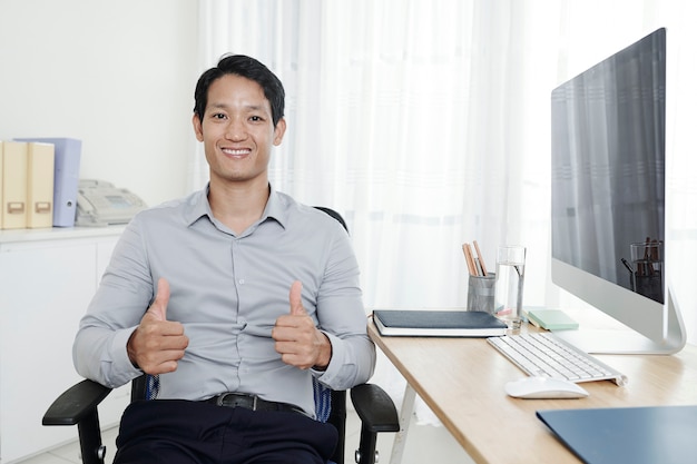 Happy entrepreneur showing thumbs-up