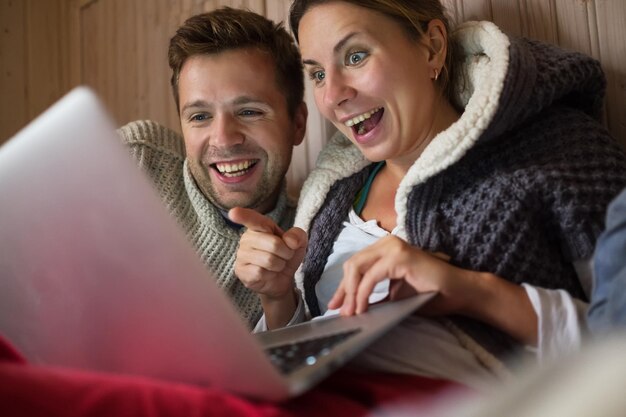 Happy european family making shopping in internet using laptop