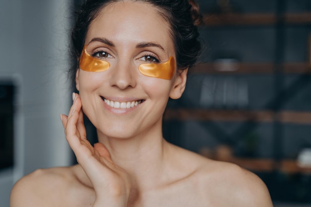 Happy european girl doing spa procedures and touches her face skin Relaxation and skincare