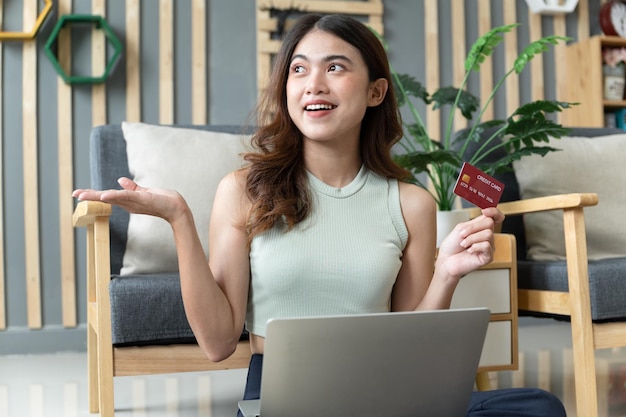 Happy excited Asia woman woking with notebook computer in living room at home