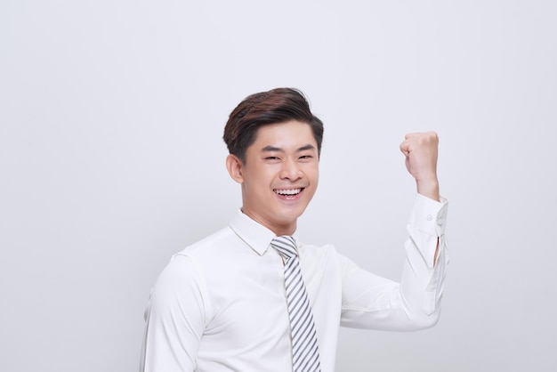 Happy excited man screaming and celebrating success with one fist up over white background