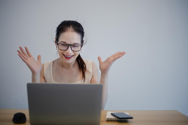 Happy excited successful woman working with her laptop