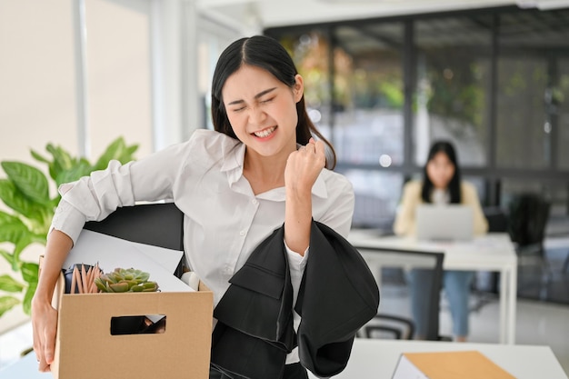 Happy and excited young Asian female office worker celebrating her resignation