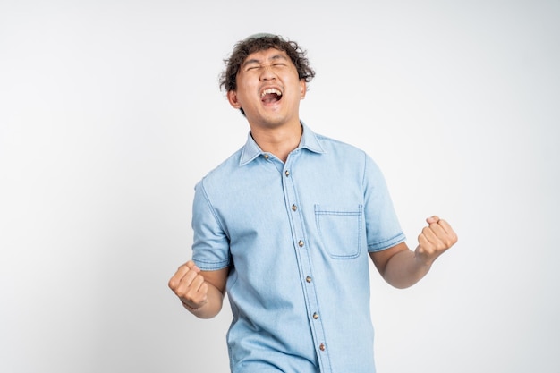 Happy excited young man over isolated background