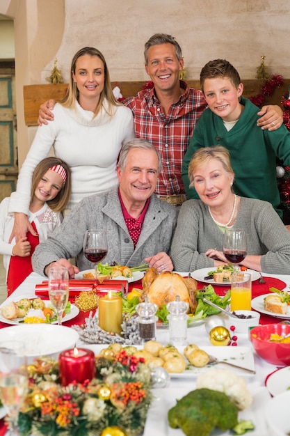 Happy extended family looking at camera at christmas time