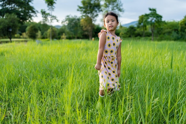 Happy face expression little girl at grass field.