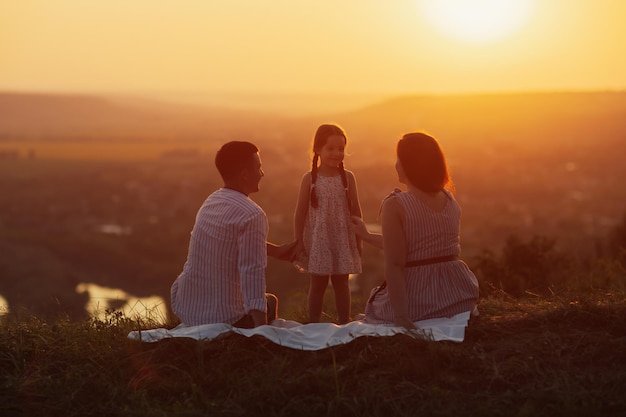 Happy family at amazing sunset