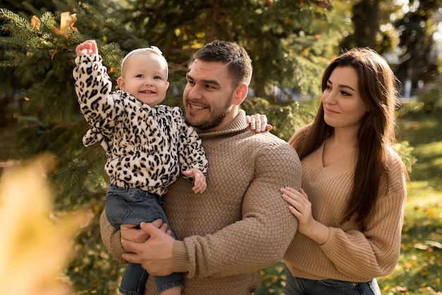 Happy family in the autumn park laughing