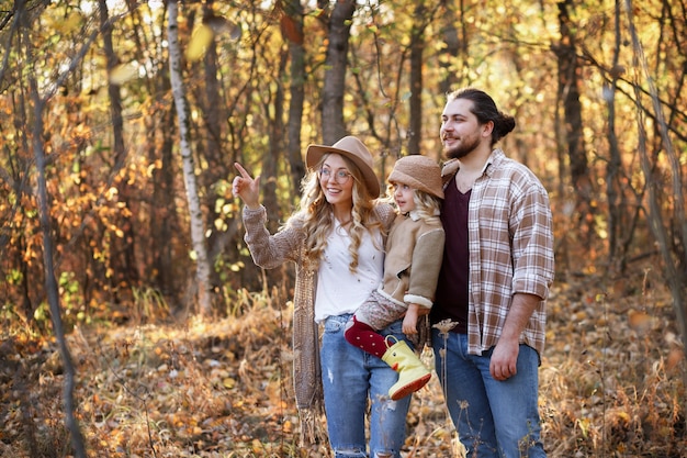 happy family on an autumn walk in the forest