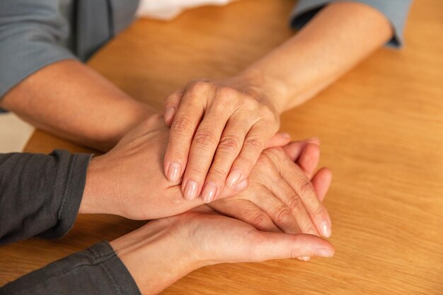 Happy family caring woman hands holding hands loving older woman mother grown up daughter and mom