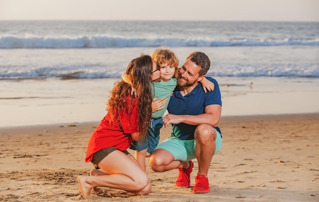 Happy family and child enjoying sunset in the beach summer leisure