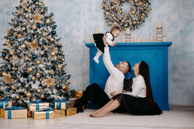 happy family on christmas eve at the tree