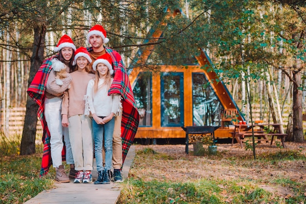 Happy family on Christmas vacation. Parent with kids wrapped in a blanket