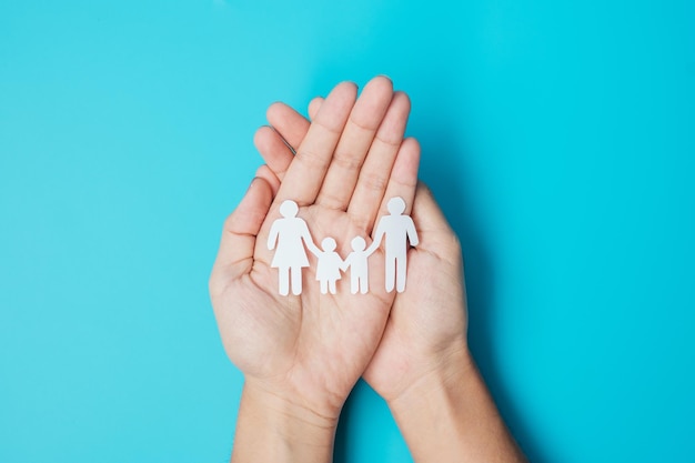 Happy Family day hands holding paper shape cutout with Father Mother and Children international day of families Warm home Homeless Foster Insurance Charity and Donation concepts