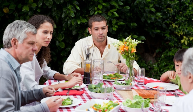 Happy family eating in the garden