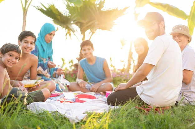 Happy family enjoying picnic on beach near sea