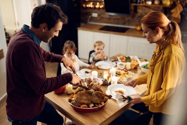 Happy family enjoying in Thanksgiving dinner in dining room