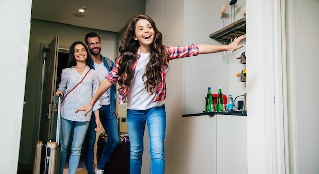 A happy family entering the hotel room