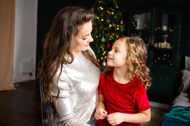 Happy family family mother and child at home near Christmas tree